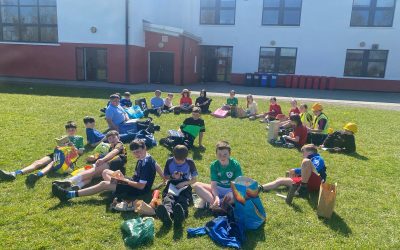 5th Class enjoying reading in the sun